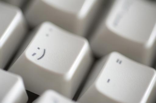 cheeky emoticon on a computer keyboard