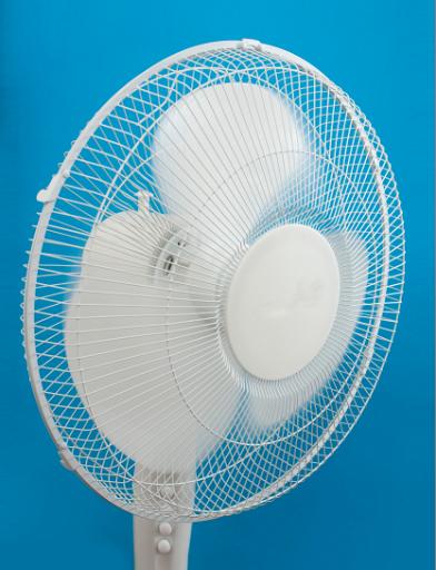 Cool image of a circular white metal portable electric cooling fan with white blades and wire mesh protection to beat the summer heat over a cool blue background