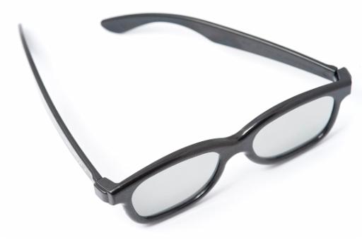 Retro glasses or spectacles with heavy black plastic frames on a white background, high angle view