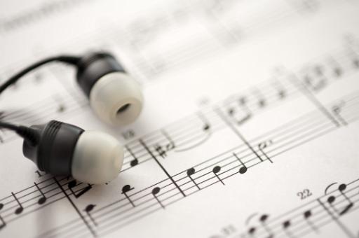 sheet music and earbud headphones