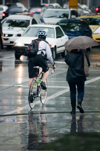 cyclist and pedestrian on a rainy day