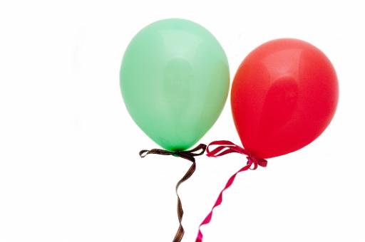 red and green party baloons on white background