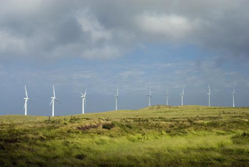 a line of wind power generators on a hilltop