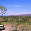 4x4 vehicle towing a trailer parked under a small tree overlooking an expanse of beautiful scenic countryside while out enjoying an Australian outback safari